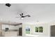 Bright living room with modern fan, recessed lighting, and view to the backyard at 19092 Woodbine Ave, Port Charlotte, FL 33954