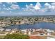 A scenic aerial view showcases the waterfront home, complete with a private boat dock on a canal community at 211 E Tarpon Nw Blvd, Port Charlotte, FL 33952