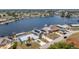 View of multiple houses on the waterfront with boat docks, solar panels and pools at 211 E Tarpon Nw Blvd, Port Charlotte, FL 33952