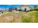 Home exterior showing the yard, screened patio, and canal views at 211 E Tarpon Nw Blvd, Port Charlotte, FL 33952