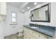 Accessible bathroom featuring granite counters, storage, and handrails at 211 E Tarpon Nw Blvd, Port Charlotte, FL 33952