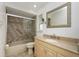 Updated bathroom with a granite countertop and a shower with glass doors at 211 E Tarpon Nw Blvd, Port Charlotte, FL 33952