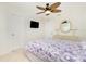 Relaxing bedroom with ceiling fan, comfy bed, and decorative lamps on top of a white dresser at 211 E Tarpon Nw Blvd, Port Charlotte, FL 33952