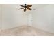 Bright bedroom with neutral carpet, a ceiling fan, and a door at 211 E Tarpon Nw Blvd, Port Charlotte, FL 33952