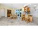 Dining area with table, chairs, and open access to a kitchen bar and screened outdoor patio at 211 E Tarpon Nw Blvd, Port Charlotte, FL 33952