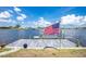 Private wooden dock on the water features an American flag and bench, perfect for enjoying waterfront views at 211 E Tarpon Nw Blvd, Port Charlotte, FL 33952