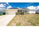 Charming single-story home featuring a two-car garage, solar panels, and a well-maintained lawn at 211 E Tarpon Nw Blvd, Port Charlotte, FL 33952
