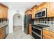 Well-lit kitchen featuring stainless steel appliances, granite countertops, and ample cabinet space at 211 E Tarpon Nw Blvd, Port Charlotte, FL 33952