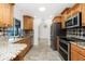 Bright kitchen with stainless steel appliances, granite counters, tile backsplash, and ample cabinet space at 211 E Tarpon Nw Blvd, Port Charlotte, FL 33952