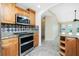 Modern kitchen featuring stainless steel double oven, a range hood, and granite countertops at 211 E Tarpon Nw Blvd, Port Charlotte, FL 33952