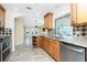 Well-lit kitchen featuring granite countertops, stainless steel appliances, and a breakfast bar at 211 E Tarpon Nw Blvd, Port Charlotte, FL 33952