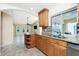 Open kitchen with a breakfast bar, granite countertops, and stainless steel appliances, seamlessly flowing into the living area at 211 E Tarpon Nw Blvd, Port Charlotte, FL 33952