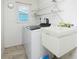 Laundry room featuring a washer and utility sink at 211 E Tarpon Nw Blvd, Port Charlotte, FL 33952