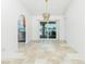 Spacious living area with tile floors, chandelier, and access to the lanai with water view at 211 E Tarpon Nw Blvd, Port Charlotte, FL 33952