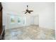 Well-lit living room with tile floors, large windows, and an open entry at 211 E Tarpon Nw Blvd, Port Charlotte, FL 33952