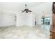 Open floor plan with living area, chandelier and water views through the glass slider to screened in porch at 211 E Tarpon Nw Blvd, Port Charlotte, FL 33952