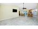 Open concept living area with tile floors adjacent to the dining area and kitchen bar at 211 E Tarpon Nw Blvd, Port Charlotte, FL 33952