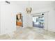 Bright living area featuring tile flooring, chandelier, and slider doors to the screened patio at 211 E Tarpon Nw Blvd, Port Charlotte, FL 33952