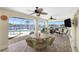 Covered patio featuring comfortable seating, a grill, and views of the waterfront and swimming pool at 211 E Tarpon Nw Blvd, Port Charlotte, FL 33952
