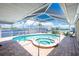 Screened-in pool and spa area with a waterway view at 211 E Tarpon Nw Blvd, Port Charlotte, FL 33952