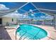 Screened-in pool and spa with waterfront views and brick patio at 211 E Tarpon Nw Blvd, Port Charlotte, FL 33952