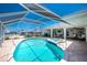 Pool and spa area with outdoor patio, ceiling fans, and view of the canal at 211 E Tarpon Nw Blvd, Port Charlotte, FL 33952
