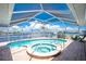Inviting covered pool and hot tub offer a relaxing outdoor experience with views of the waterway at 211 E Tarpon Nw Blvd, Port Charlotte, FL 33952