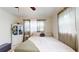 Bright bedroom features a queen bed, multiple windows with curtains, and ample natural light at 2142 Gerard Ct, Port Charlotte, FL 33952