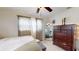 Bedroom with dark wood dresser, large mirror, multiple windows, a queen bed, and soft decor at 2142 Gerard Ct, Port Charlotte, FL 33952
