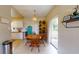 Cozy dining area features a round table, wood chairs, chandelier, and sliding glass doors to the backyard at 2142 Gerard Ct, Port Charlotte, FL 33952