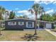 Charming single-story home featuring a well-maintained yard, white trim, and complemented by a mature palm tree at 2142 Gerard Ct, Port Charlotte, FL 33952