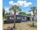 Single-story house features a well-maintained yard and mature palm trees complementing the home's exterior at 2142 Gerard Ct, Port Charlotte, FL 33952