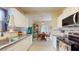 Kitchen and dining area featuring stainless steel appliances, white cabinets, and granite countertops at 2142 Gerard Ct, Port Charlotte, FL 33952