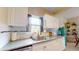 Bright kitchen features stainless steel appliances, white cabinets, granite countertops and an undermount sink at 2142 Gerard Ct, Port Charlotte, FL 33952
