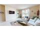 Inviting living room with a comfortable sectional, white wall accents, and ample natural light creating a warm ambiance at 2142 Gerard Ct, Port Charlotte, FL 33952