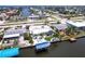 Waterfront home featuring a boat dock, well-maintained landscaping, and a white stone backyard at 21812 Edgewater Dr, Port Charlotte, FL 33952