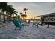 Private backyard with boat dock, waterfront views, and cozy seating area at 21812 Edgewater Dr, Port Charlotte, FL 33952