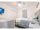 Bright bedroom features a queen bed, TV, ceiling fan, and closet at 21812 Edgewater Dr, Port Charlotte, FL 33952
