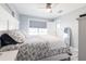 Well-lit bedroom with a queen bed, ceiling fan, and white door at 21812 Edgewater Dr, Port Charlotte, FL 33952