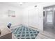 Bright bedroom featuring modern decor, light wood floors, and hallway access at 21812 Edgewater Dr, Port Charlotte, FL 33952