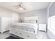 Bright bedroom features a ceiling fan, ample natural light, and stylish white furniture at 21812 Edgewater Dr, Port Charlotte, FL 33952