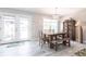 Dining room with rustic wood table, bench, wood floors, and natural light at 21812 Edgewater Dr, Port Charlotte, FL 33952