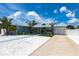 Charming single-story home with beautiful landscaping, driveway, and white picket fence at 21812 Edgewater Dr, Port Charlotte, FL 33952