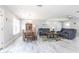 Spacious living room with gray sofas, wood table, dining area, and hardwood-style flooring at 21812 Edgewater Dr, Port Charlotte, FL 33952