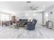 Open-concept living room with hardwood floors, ceiling fan, dining table, and comfortable seating at 21812 Edgewater Dr, Port Charlotte, FL 33952