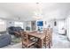 Open-concept space with a dining table, living room area, kitchen, hardwood-style floors, and lots of light at 21812 Edgewater Dr, Port Charlotte, FL 33952