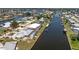 A luxurious waterfront property is displayed, with a screened-in pool and direct access to the serene open waters at 233 Beeney Se Rd, Port Charlotte, FL 33952