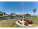 Lush backyard landscaping with serene water views and comfortable outdoor seating at 233 Beeney Se Rd, Port Charlotte, FL 33952