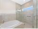 Bathroom boasting a glass shower and a built-in tub at 233 Beeney Se Rd, Port Charlotte, FL 33952