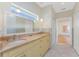 Bathroom with dual sinks, granite countertops, and decorative mirror, offering a luxurious and functional space at 233 Beeney Se Rd, Port Charlotte, FL 33952